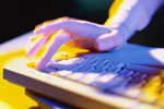 Image of a hand on a computer keyboard 